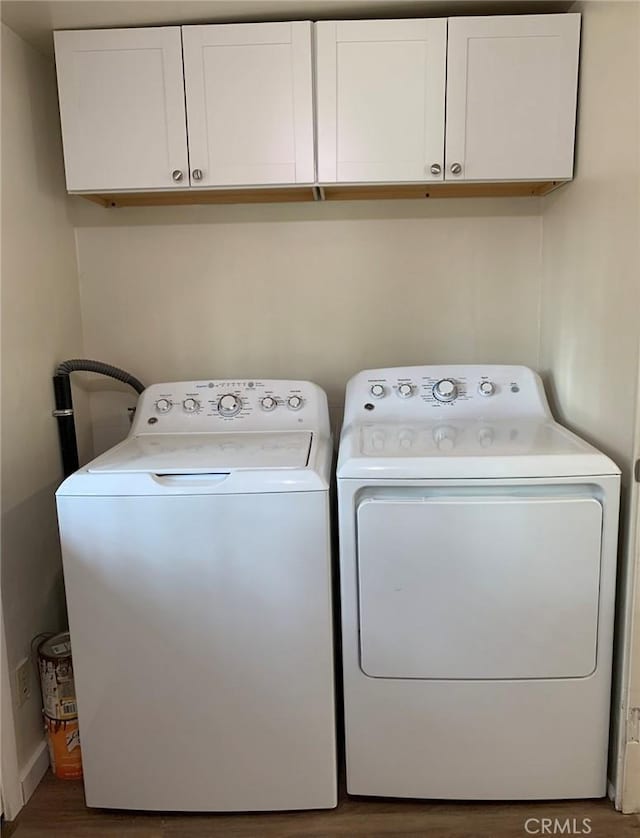 1326 Mulberry St, Chico, CA 95928 - laundry room with cabinet space, washing machine and dryer, and wood finished floors