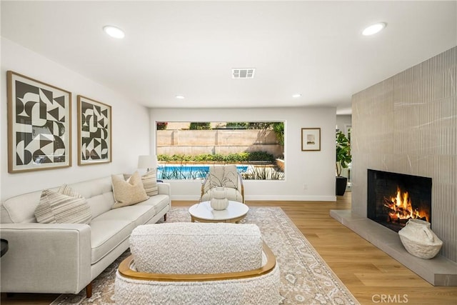121 W Borromeo Ave, Placentia, CA 92870 - living area featuring a fireplace, recessed lighting, and wood finished floors