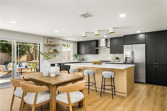 121 W Borromeo Ave, Placentia, CA 92870 - kitchen with stainless steel fridge with ice dispenser, wall chimney range hood, dark cabinetry, light countertops, and recessed lighting