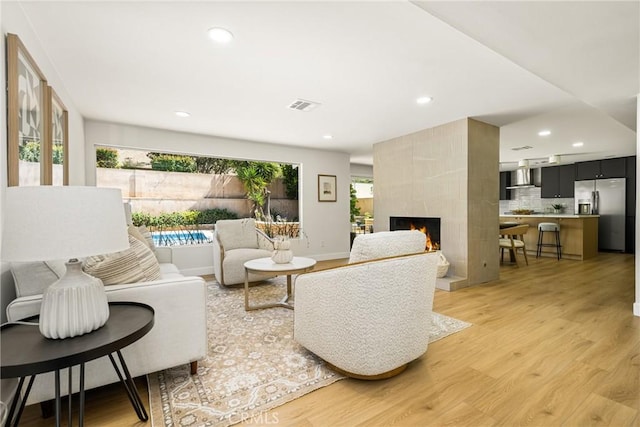 121 W Borromeo Ave, Placentia, CA 92870 - living area featuring light wood-type flooring, a fireplace, and recessed lighting
