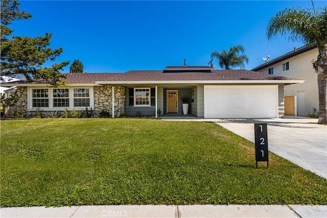 121 W Borromeo Ave, Placentia, CA 92870 - single story home featuring an attached garage, roof mounted solar panels, a front lawn, driveway, and stone siding