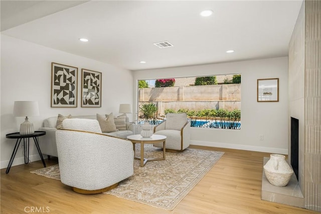 121 W Borromeo Ave, Placentia, CA 92870 - living area featuring wood finished floors, recessed lighting, and a large fireplace