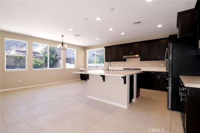 28245 Nield Ct, Saugus, CA 91350 - kitchen featuring a kitchen breakfast bar, a chandelier, light countertops, recessed lighting, and freestanding refrigerator