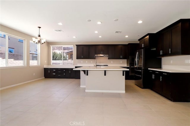 28245 Nield Ct, Saugus, CA 91350 - kitchen with a chandelier, a breakfast bar, light countertops, smart refrigerator, and under cabinet range hood