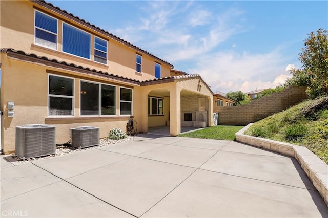 28245 Nield Ct, Saugus, CA 91350 - rear view of property featuring stucco siding, a patio, and a tile roof