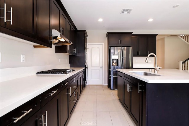 28245 Nield Ct, Saugus, CA 91350 - kitchen featuring under cabinet range hood, appliances with stainless steel finishes, light countertops, light tile patterned floors, and recessed lighting