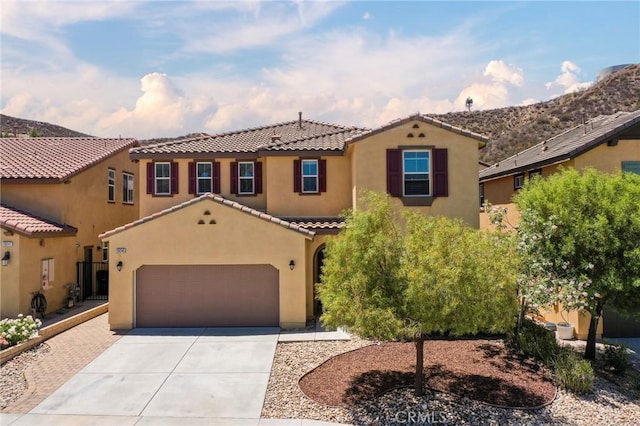 28245 Nield Ct, Saugus, CA 91350 - mediterranean / spanish-style house featuring concrete driveway, stucco siding, a tiled roof, and a garage