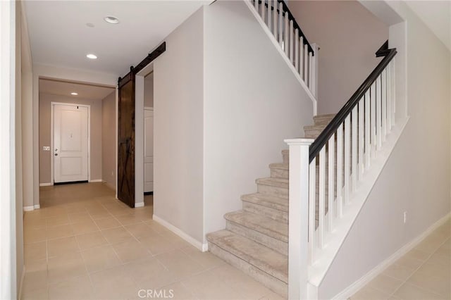 28245 Nield Ct, Saugus, CA 91350 - stairs featuring a barn door, tile patterned flooring, and recessed lighting