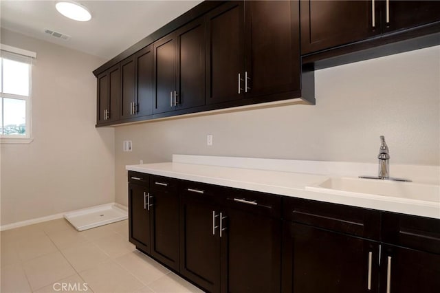 28245 Nield Ct, Saugus, CA 91350 - laundry area with cabinet space, light tile patterned flooring, and hookup for a washing machine