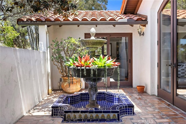 2575 Temple Hills Dr, Laguna Beach, CA 92651 - entrance to property featuring a tile roof, stucco siding, and french doors
