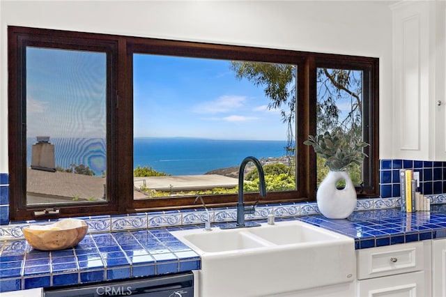 2575 Temple Hills Dr, Laguna Beach, CA 92651 - kitchen featuring tile countertops, white cabinetry, backsplash, a water view, and dishwasher