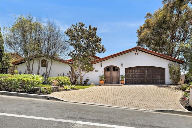 2575 Temple Hills Dr, Laguna Beach, CA 92651 - mediterranean / spanish-style home with stucco siding, a garage, and decorative driveway
