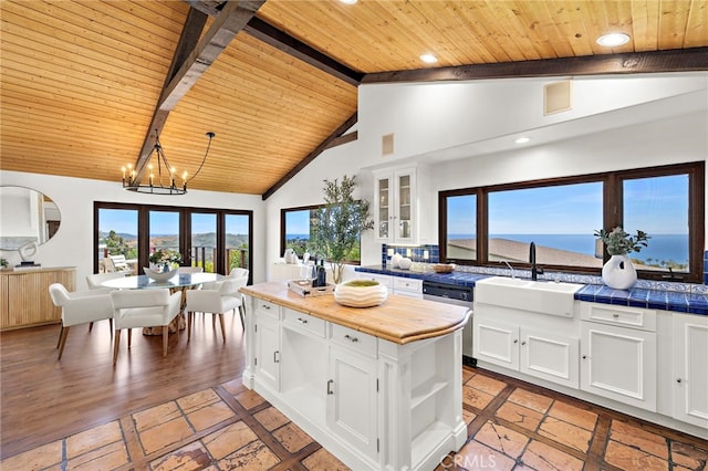 2575 Temple Hills Dr, Laguna Beach, CA 92651 - kitchen featuring a wood ceiling with exposed beams, a chandelier, white cabinets, recessed lighting, and glass insert cabinets