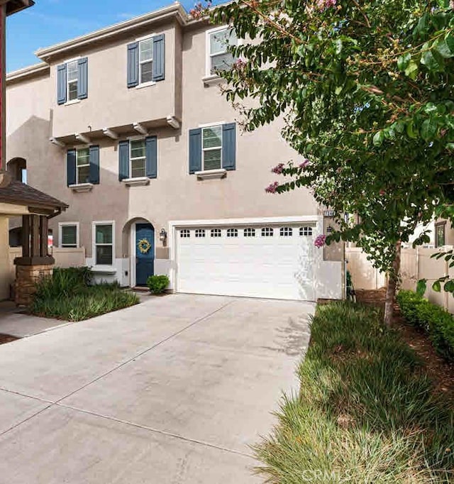 7346 Garnet Ridge Rd, Jurupa Valley, CA 92509 - view of front of home with driveway, stucco siding, and an attached garage