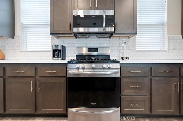 7346 Garnet Ridge Rd, Jurupa Valley, CA 92509 - kitchen with stainless steel appliances, dark brown cabinetry, light countertops, and backsplash