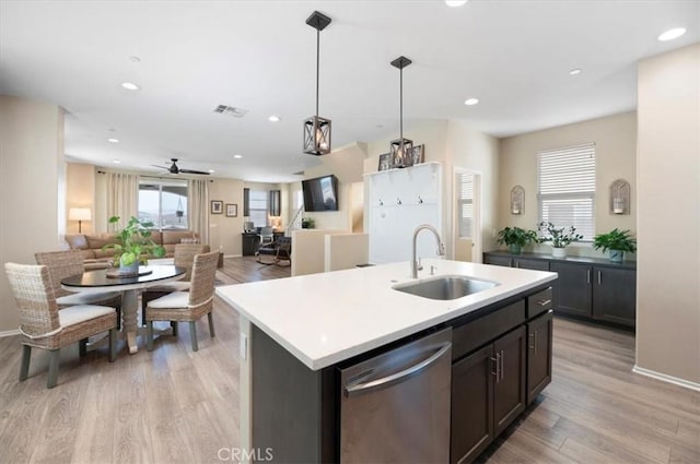 7346 Garnet Ridge Rd, Jurupa Valley, CA 92509 - kitchen featuring dishwasher, light wood finished floors, a ceiling fan, open floor plan, and a kitchen island with sink