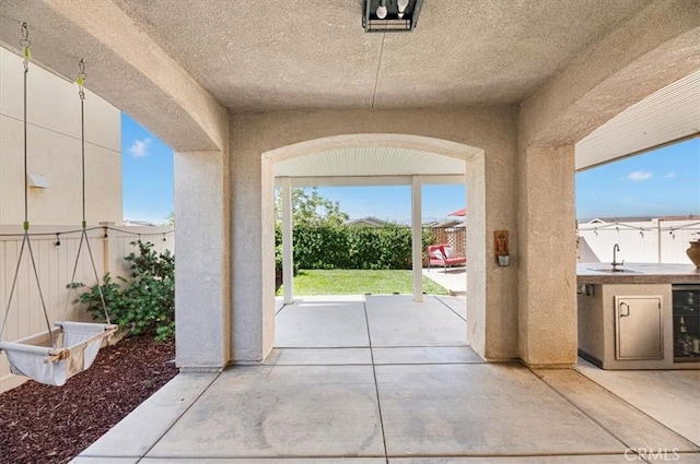 7346 Garnet Ridge Rd, Jurupa Valley, CA 92509 - fenced backyard with a patio, wine cooler, and an outdoor kitchen