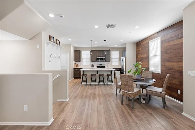 7346 Garnet Ridge Rd, Jurupa Valley, CA 92509 - dining room with light wood-style flooring, wooden walls, and recessed lighting