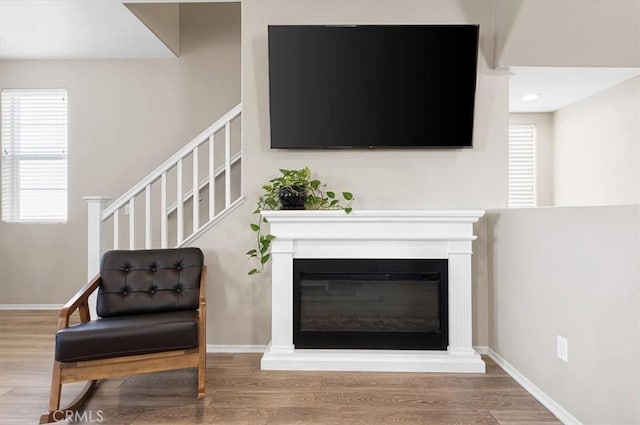 7346 Garnet Ridge Rd, Jurupa Valley, CA 92509 - living room with wood finished floors, stairway, and a glass covered fireplace