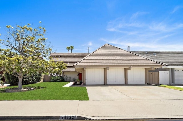 20822 Skimmer Ln, Huntington Beach, CA 92646 - view of front of home featuring a tiled roof, driveway, and a garage