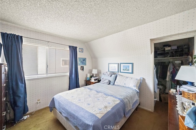 20822 Skimmer Ln, Huntington Beach, CA 92646 - carpeted bedroom with wallpapered walls, a textured ceiling, a walk in closet, and lofted ceiling