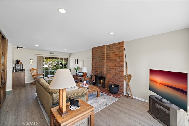 20822 Skimmer Ln, Huntington Beach, CA 92646 - living room featuring wood finished floors, recessed lighting, and a fireplace