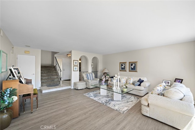 20822 Skimmer Ln, Huntington Beach, CA 92646 - living room with wood finished floors, stairs, and arched walkways