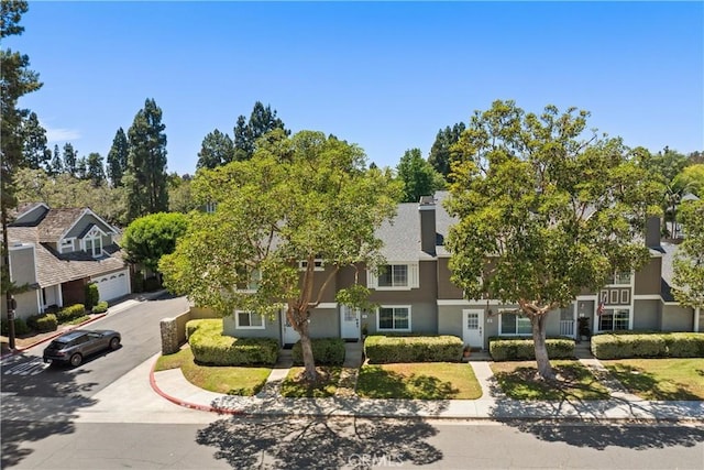 53 Misty Run Unit 10, Irvine, CA 92614 - view of front of house featuring stucco siding, a garage, driveway, and a residential view