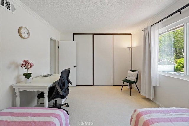 53 Misty Run Unit 10, Irvine, CA 92614 - bedroom featuring crown molding, a textured ceiling, light colored carpet, and a closet