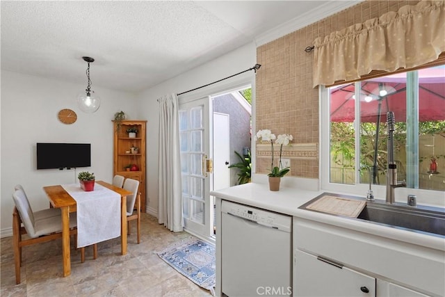 53 Misty Run Unit 10, Irvine, CA 92614 - kitchen featuring dishwasher, light countertops, white cabinets, hanging light fixtures, and a textured ceiling