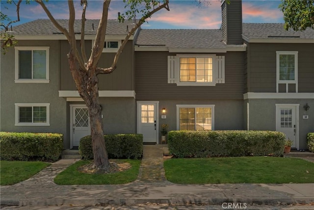 53 Misty Run Unit 10, Irvine, CA 92614 - townhome / multi-family property with stucco siding, a chimney, and a front yard
