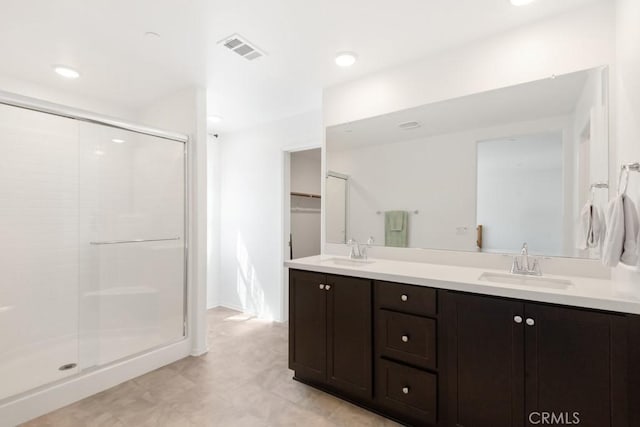 32985 Middlegate Pl, Lake Elsinore, CA 92530 - full bath featuring a stall shower, double vanity, tile patterned floors, and a spacious closet