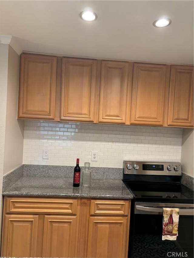 5585 E Pacific Coast Hwy Unit 154, Long Beach, CA 90804 - kitchen featuring stainless steel range with electric cooktop, decorative backsplash, recessed lighting, dark stone countertops, and brown cabinetry