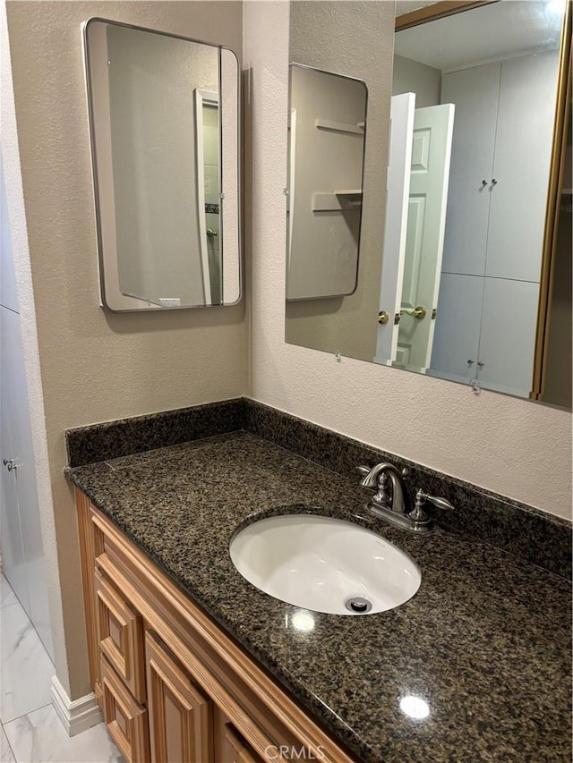5585 E Pacific Coast Hwy Unit 154, Long Beach, CA 90804 - bathroom featuring marble look tiles and vanity