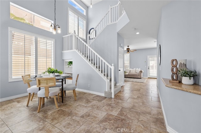 31 Cayman Brac, Aliso Viejo, CA 92656 - dining area featuring stairway, a towering ceiling, plenty of natural light, a ceiling fan, and a chandelier