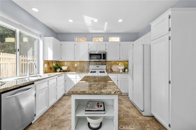 31 Cayman Brac, Aliso Viejo, CA 92656 - kitchen with appliances with stainless steel finishes, open shelves, light stone counters, tasteful backsplash, and recessed lighting