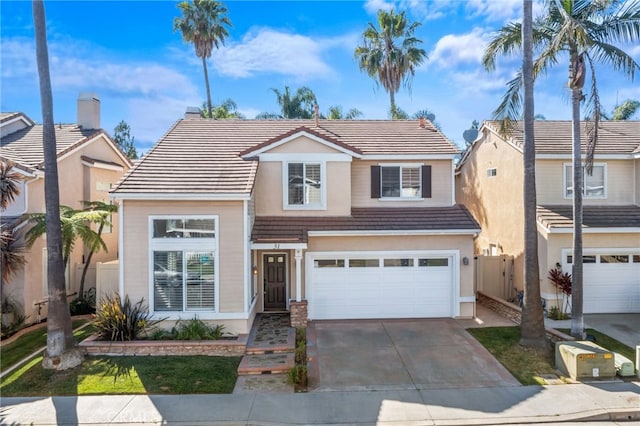 31 Cayman Brac, Aliso Viejo, CA 92656 - traditional-style home with a garage, a tiled roof, and driveway