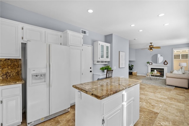 31 Cayman Brac, Aliso Viejo, CA 92656 - kitchen with white fridge with ice dispenser, a ceiling fan, a kitchen island, light stone countertops, and recessed lighting