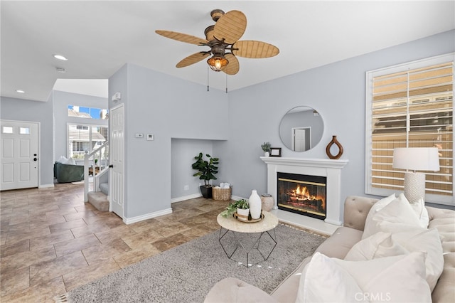 31 Cayman Brac, Aliso Viejo, CA 92656 - living area with stairs, a glass covered fireplace, a ceiling fan, recessed lighting, and stone finish floors