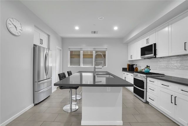2930 Rowena Ave Unit 4, Los Angeles, CA 90039 - kitchen with appliances with stainless steel finishes, dark countertops, tasteful backsplash, recessed lighting, and a kitchen breakfast bar