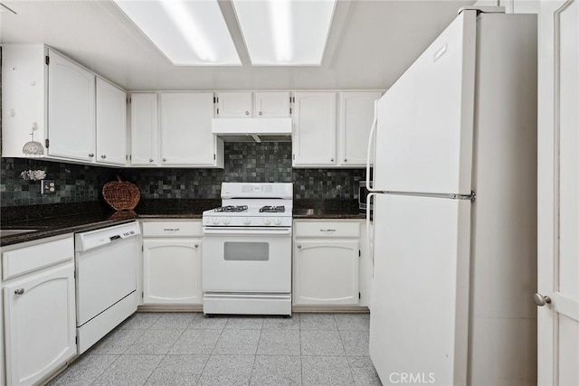14325 Foothill Blvd Unit 34, Sylmar, CA 91342 - kitchen with white appliances, under cabinet range hood, decorative backsplash, white cabinets, and dark stone countertops
