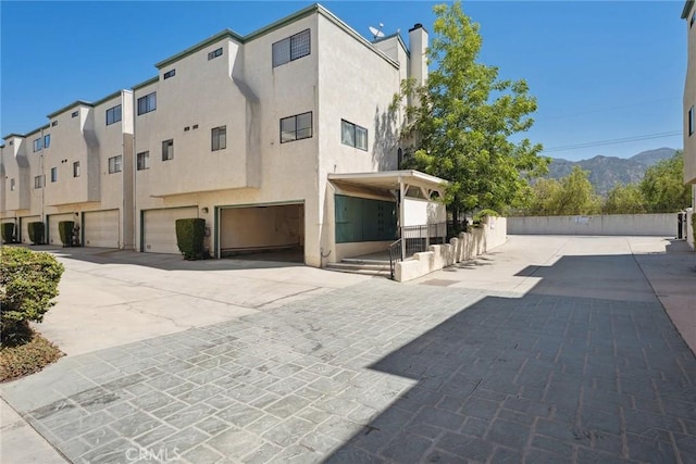 14325 Foothill Blvd Unit 34, Sylmar, CA 91342 - view of building exterior with a garage and driveway