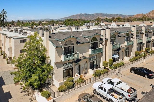 14325 Foothill Blvd Unit 34, Sylmar, CA 91342 - view of property featuring a mountain view, a residential view, and uncovered parking