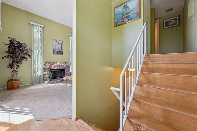 14325 Foothill Blvd Unit 34, Sylmar, CA 91342 - stairway featuring a brick fireplace and carpet flooring