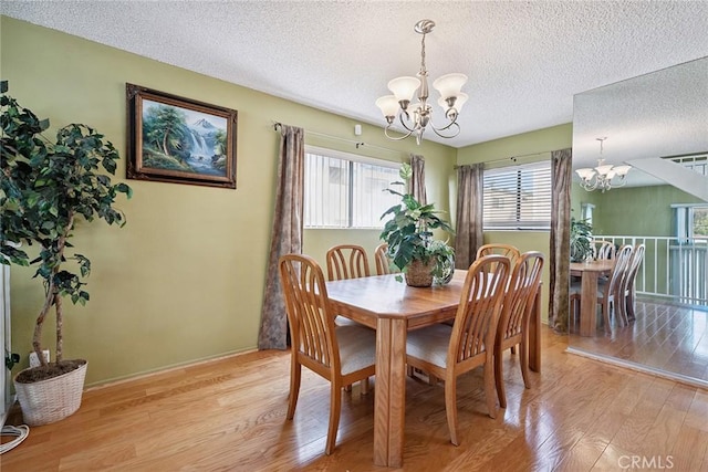 14325 Foothill Blvd Unit 34, Sylmar, CA 91342 - dining space featuring a chandelier, light wood-style floors, and a textured ceiling