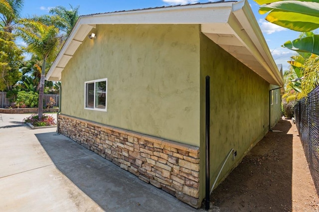 1740 Fire Mountain Dr, Oceanside, CA 92054 - view of side of home with stucco siding and a patio area