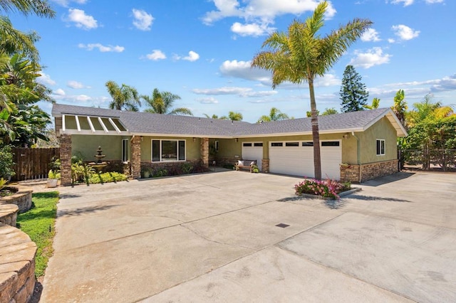 1740 Fire Mountain Dr, Oceanside, CA 92054 - view of front facade with stone siding, driveway, stucco siding, and an attached garage