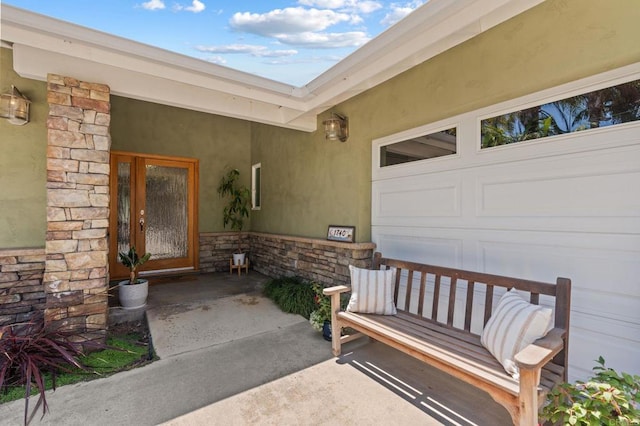 1740 Fire Mountain Dr, Oceanside, CA 92054 - property entrance with stone siding, a porch, stucco siding, and a garage