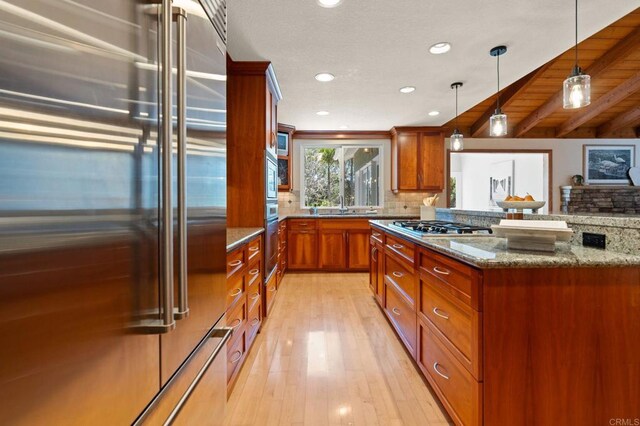 1740 Fire Mountain Dr, Oceanside, CA 92054 - kitchen featuring stainless steel appliances, brown cabinets, stone countertops, recessed lighting, and backsplash