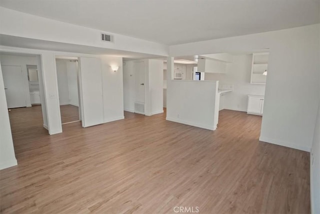 1138 N Valley St, Burbank, CA 91505 - unfurnished living room with light wood-style floors and baseboards